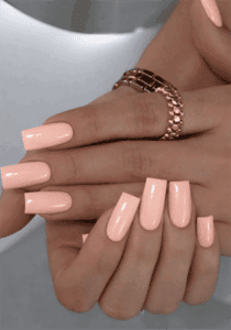 Glossy peach nude coffin nails with solid pastel finish, minimalist acrylic nail design on long square nails