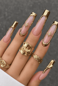 Gold chrome outline coffin nails with nude pink base, luxury metallic frame nail design featuring celestial star accents
