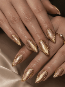 Gold velvet chrome almond nails with metallic cat eye shimmer, luxury nail design featuring gold outline accents and glossy finish