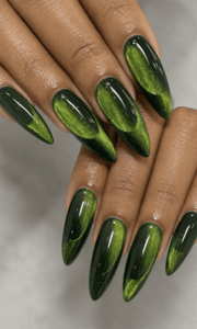 Emerald green cat eye almond nails with magnetic shimmer effect, glossy metallic nail design on long almond nails