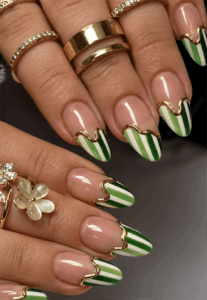 Green striped French tip almond nails with gold chrome outline, glossy nude base nail design featuring elegant wave detailing
