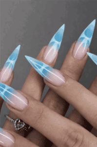 Icy blue aura stiletto nails with nude base, glossy gradient nail design with abstract swirl accents