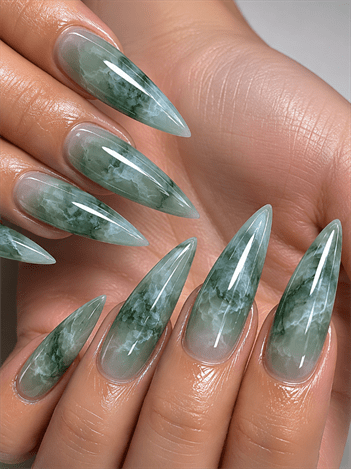 Jade marble stiletto nails with translucent green gemstone effect, glossy crystal-inspired nail design on long pointed nails