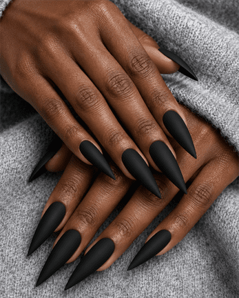 Matte black stiletto nails with sleek monochrome finish, edgy long pointed nail design