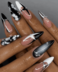 Monochrome chrome stiletto nails with black, white and silver metallic accents, glossy abstract nail design