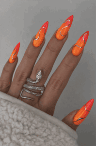 Neon orange and pink chrome wave stiletto nails with glossy finish, abstract swirl nail design on long nails