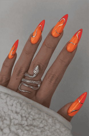 Neon orange and pink chrome wave stiletto nails with glossy finish, abstract swirl nail design on long nails