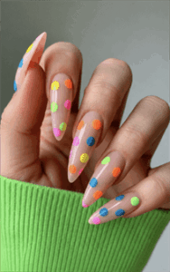Neon polka dot jelly stiletto nails with translucent nude base, colorful glossy dotted nail design