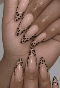 Nude leopard print French tip stiletto nails with glossy finish, animal print nail design on long nails