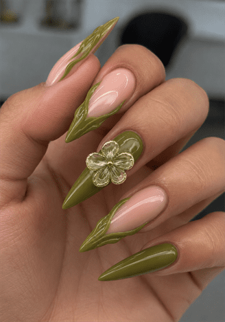 Olive green flame stiletto nails with 3D flower accent, glossy nude base nail design featuring botanical details
