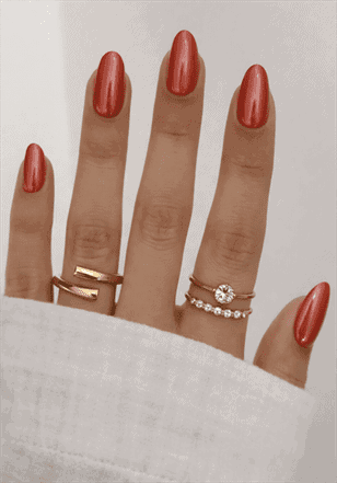 Orange chrome almond nails with metallic glossy finish, shimmering burnt orange nail design on long nails