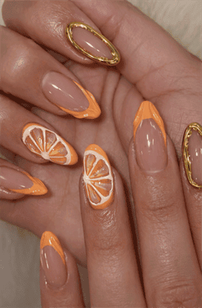 Orange citrus French tip almond nails with 3D fruit slices, glossy nude base summer nail design