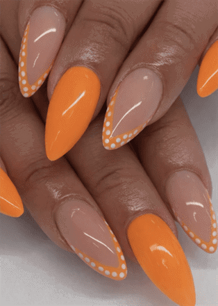 Orange French tip almond nails with polka dot outline, glossy nude base bright nail design”