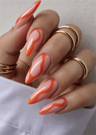 Orange swirl stiletto nails with nude base, glossy abstract wave nail design on long pointed nails