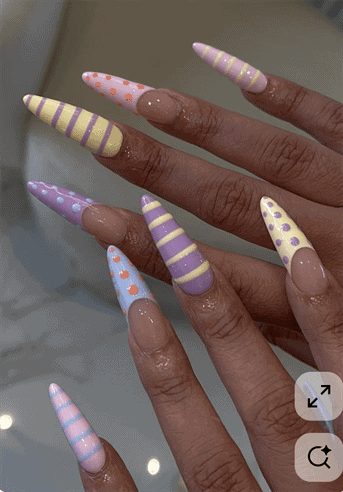 Pastel mix and match stiletto nails with stripes and polka dots, glossy nude base long nail design