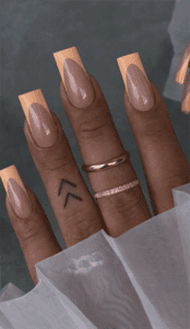 Peach French tip coffin nails with nude base, glossy minimalist acrylic nail design on long square nails