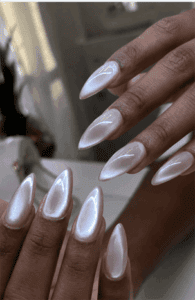 Pearlescent glazed almond nails with chrome shimmer finish, glossy milky white glazed donut nail design