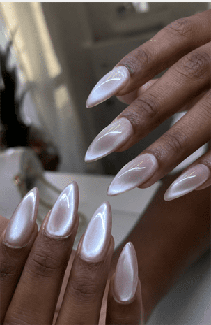 Pearlescent glazed almond nails with chrome shimmer finish, glossy milky white glazed donut nail design