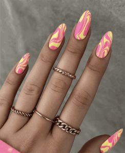 Pink lemonade swirl almond nails with glossy finish, yellow and pink retro wave nail design on long nails