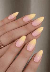 Pink and yellow ombre almond nails with glossy finish, soft pastel gradient nail design on long nails