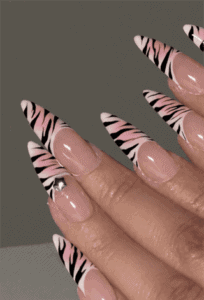Pink zebra print French tip stiletto nails with glossy finish, nude base animal print nail design