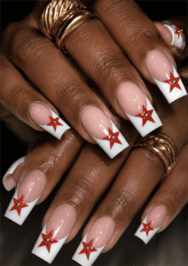 Retro star French tip coffin nails with white tips and red star accents, glossy nude base nail design