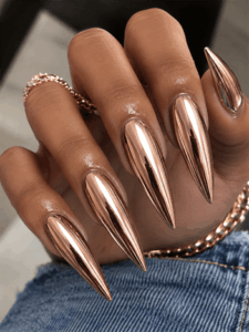 Rose gold chrome stiletto nails with mirror metallic finish, luxury reflective nail design on long pointed nails