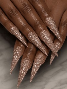 Rose gold glitter stiletto nails with full sparkle coverage, glamorous luxury nail design on long pointed nails