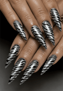 Silver chrome zebra print stiletto nails with metallic animal pattern, glossy black and silver nail design on long pointed nails