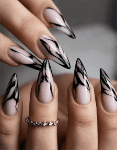 Smoky marble stiletto nails with black abstract swirl design, glossy nude base nail art on long pointed nails