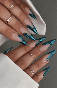 Teal chrome swirl stiletto nails with nude base, metallic abstract nail design on long pointed nails