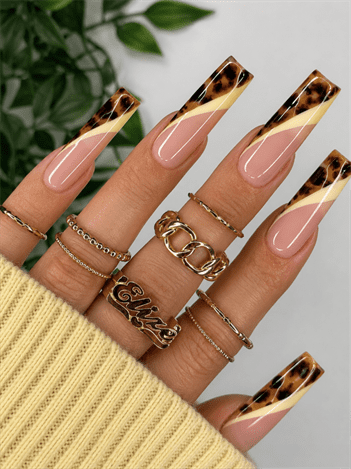 Tortoiseshell French tip coffin nails with nude pink base and cream swirl accents, glossy luxury nail design