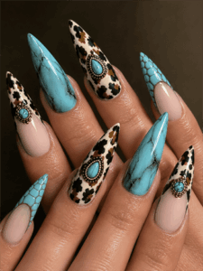 Turquoise western stiletto nails with cow print accents, gemstone nail art and desert-inspired nail design on nude base