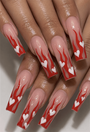Valentine flame coffin nails with red flame tips and white heart accents, glossy nude base nail design