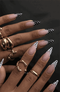 Black and white polka dot French tip almond nails with nude base, glossy retro nail design on long nails