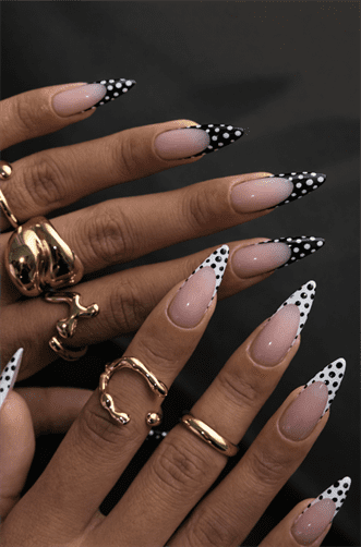 Black and white polka dot French tip almond nails with nude base, glossy retro nail design on long nails