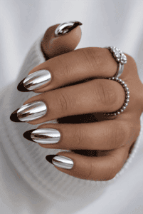 Black French mirror chrome almond nails with reflective silver metallic finish, glossy black tips and luxury minimalist nail design