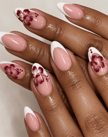 Burgundy hibiscus French tip almond nails with white tips, hand-painted floral nail art and glossy nude pink base