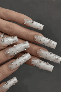 Frosted white coffin nails with silver chrome studs, 3D metallic bead embellishments and matte luxury winter nail design