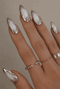 Molten chrome aura almond nails with silver mirror drip tips, pearlescent white gradient, 3D metallic detailing and luxury chrome manicure
