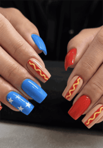 Patriotic pop art nails with hot dog nail art, blue star accent nails and red glossy manicure, fun Fourth of July nail design on coffin nails
