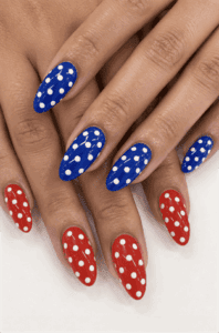 Patriotic red and blue polka dot almond nails with glossy finish, playful Fourth of July nail design featuring classic white polka dot nail art