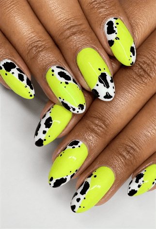 Neon yellow cow print almond nails with black and white animal print accents, glossy western-inspired manicure and bold statement nail design