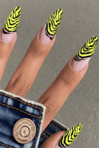 Neon yellow zebra print almond nails with black animal print French tips, glossy finish and bold safari-inspired nail design