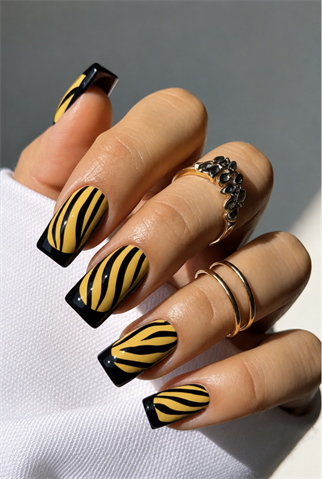 Yellow and black zebra French tip coffin nails with glossy finish, animal print nail art and bold safari-inspired manicure