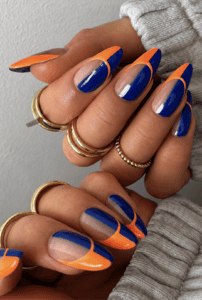 Royal blue and neon orange French tip almond nails with glossy finish, abstract color block nail design and modern summer manicure