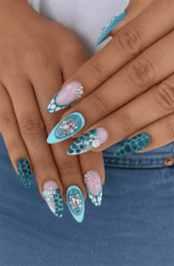 Turquoise mermaid stiletto nails with crocodile texture, rhinestone embellishments, 3D flowers and ocean-inspired luxury nail art