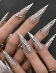 Silver chrome flame stiletto nails with liquid metal accents, glossy nude base and sculpted mirror chrome luxury nail design