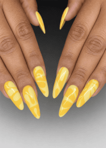 Bright yellow abstract swirl stiletto nails with glossy finish, modern retro nail design featuring tonal wave patterns on long pointed nails