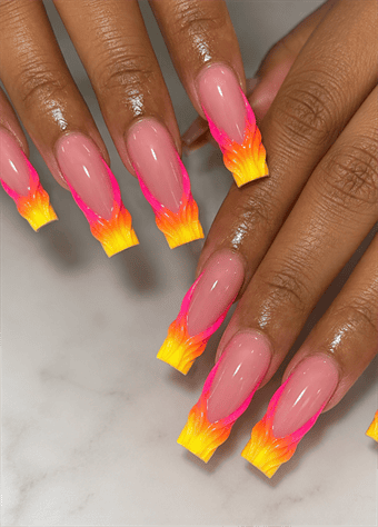 Neon pink and yellow flame French tip coffin nails with glossy nude base, fiery ombré nail art and bold summer manicure